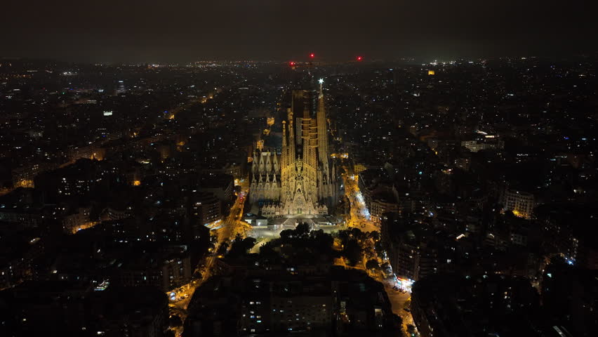 night illumination flight over barcelona city traffic street famous cathedral front exterior aerial panorama 4k spain