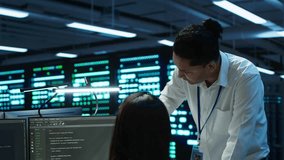 Team of admins in data center ensuring system can handle networking tasks. Teamworking colleagues in server room tracking network traffic with PC, making improvements, camera A - Powered by Shutterstock - Get 15% off with code: PIKWIZARD15