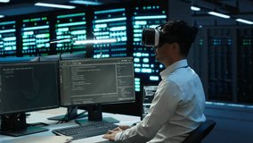 Data center admin responsible for installation of networking systems wearing high tech VR headset. IT worker doing maintenance on server farm gear using virtual reality technology, camera A - Powered by Shutterstock - Get 15% off with code: PIKWIZARD15