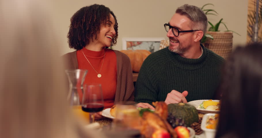 Happy family, couple and dinner for thanksgiving in home with love, food and gratitude for holiday celebration. Man, woman and hug by table with laughter or embrace, feast and reunion with relatives