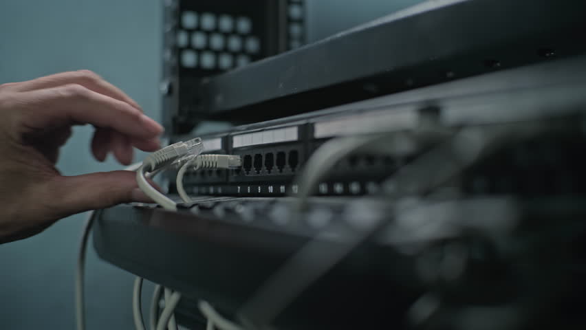 Maintenance of LAN or web servers. Close up of system administrator connecting cables with server rack, working in server room. Operation of information systems and networks. Data storage center. - Powered by Shutterstock - Get 15% off with code: PIKWIZARD15