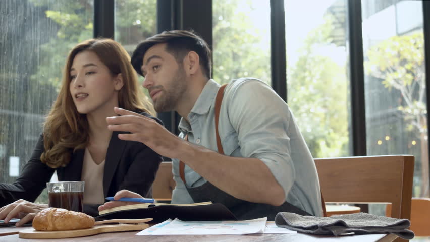 Coffee owner and business women brainstrom to decorate coffeeshop.