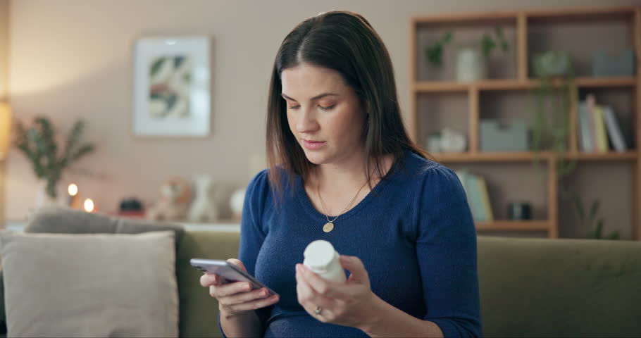 Medicine, phone and pregnant with woman on sofa in living room of home for prenatal vitamin research. Benefits, dosage or side effects of maternal medication with mother in apartment for prescription