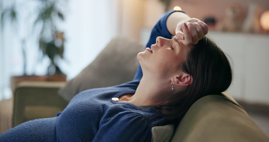 Woman, pregnant and fatigue in house for pain, indigestion and stomach cramps with breathing exercise. Motherhood, discomfort and tired in home for burnout, backache and headache with contraction