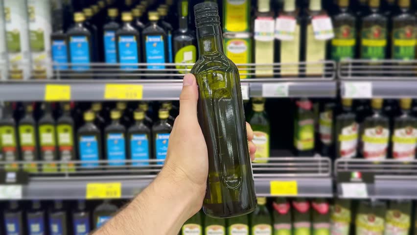 choosing olive oil, sauce, vinegar at the grocery store