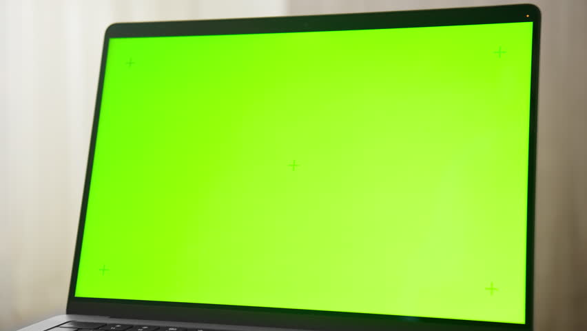 Laptop with Green Screen on Round Table