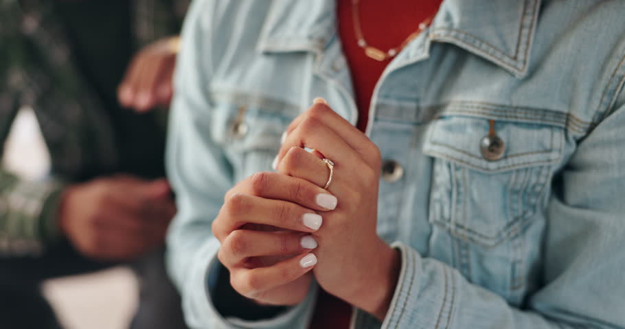 Woman, ring hand and stress for divorce with relationship conflict, infidelity and angry man in home. Wife, wedding jewelry and doubt for marriage crisis with cheating drama, sad and toxic partner