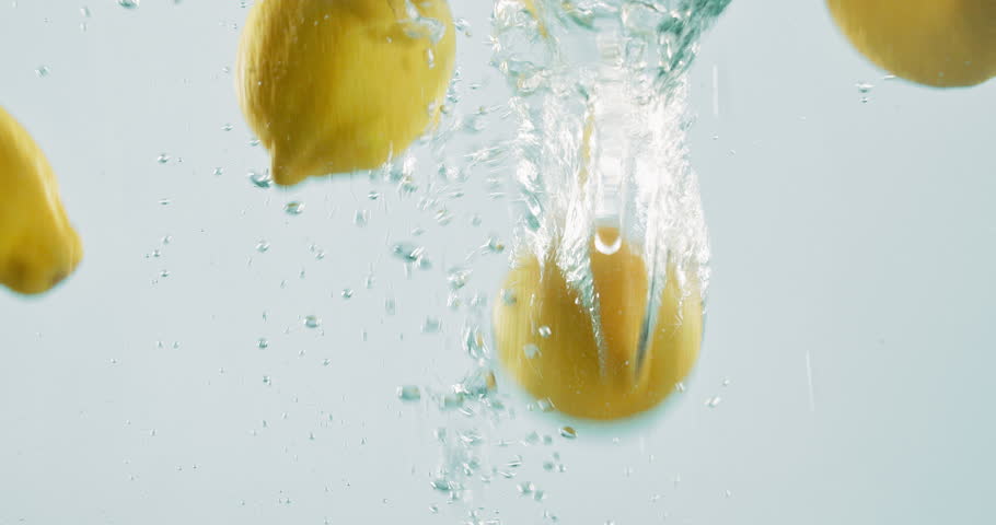 Fruit, lemon and vitamin c with water splash for nutrition, fresh produce or hydration in studio on a white background. Closeup of juicy, citric acid or wet natural organic food for healthy diet