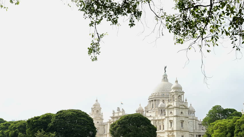 Victoria Memorial, large marble monument on the Maidan in Central Kolkata, West Bengal, India. Time lapse 4K video with monsoon sky and clouds passing over the architecture.