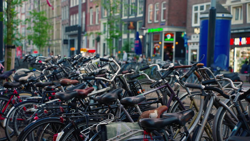 Many bicycles in Amsterdam outdoor bike parking. Ways of transportation