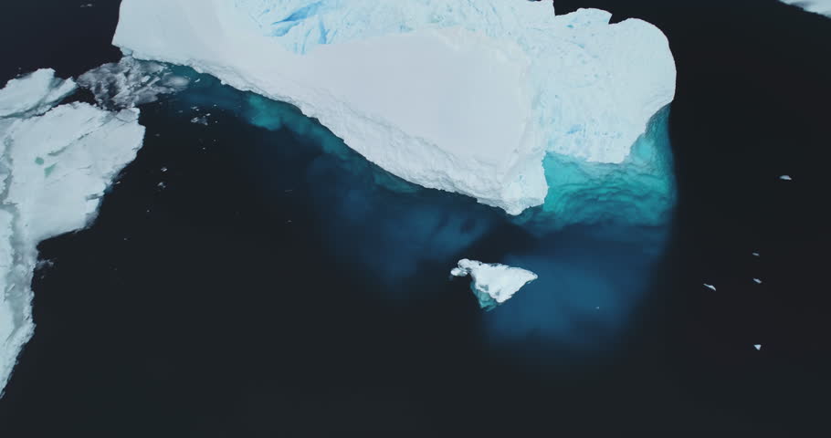 Huge ice glacier at polar nature environment. Blue water icebergs melting underwater in cold ocean in Antarctica. Ice floes aerial drone shot. Antarctic travel, explore. Global warming, climate change