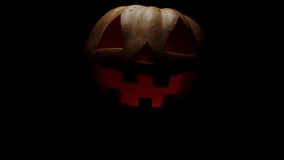 The Pumpkin Glows on Halloween Night. A Traditional Halloween Symbol. A Halloween Pumpkin Smile and Scary Eyes for the Party. Halloween Horror Concept. - Powered by Shutterstock - Get 15% off with code: PIKWIZARD15