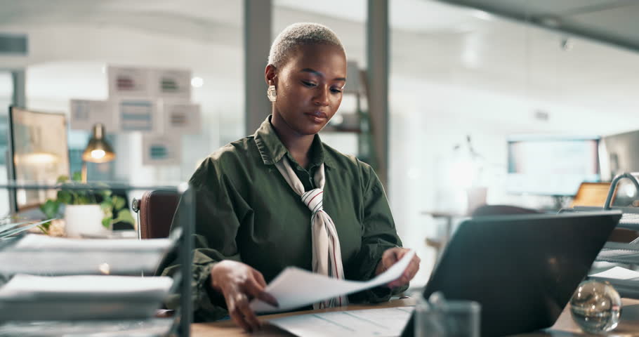 Business, black woman and documents in tray at office with laptop for company administration or record keeping. Receptionist, employee and paperwork with online management and filing reports at night