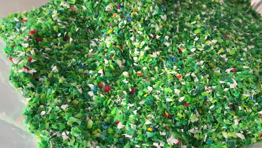 woman and plastic recycling.shredded plastic.slow motion.high quality 4K footage