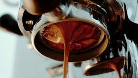 4K Pouring coffee stream from professional machine in cup. Barista man making double espresso, using filter holder. Flowing fresh ground coffee. Drinking roasted black coffee in the morning. - Powered by Shutterstock - Get 15% off with code: PIKWIZARD15
