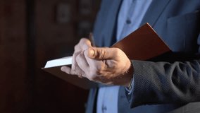 Mature businessman takes notebook and pen out of inner pocket at backlit closeup. Manager in formal jacket writes in notepad in office - Powered by Shutterstock - Get 15% off with code: PIKWIZARD15
