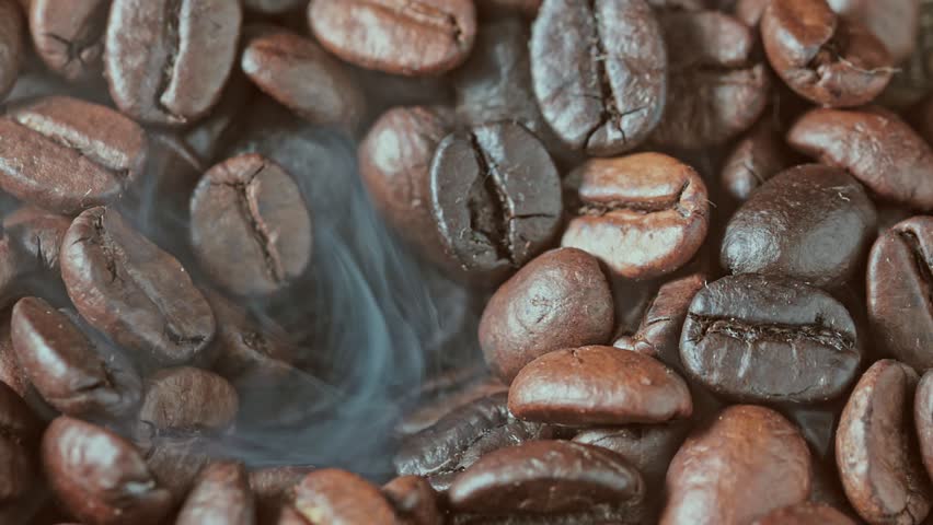 Roasting coffee beans with smoke. The smoke comes from fresh coffee beans.
