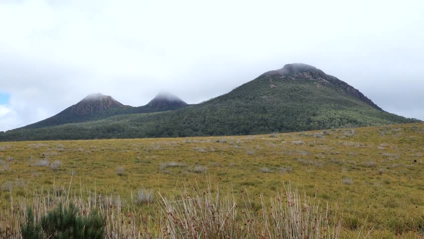 Mountain landscape in Tasmania, Australia. Cloudy and rainy weather over a high-altitude mountain range in southern Tasmania. 