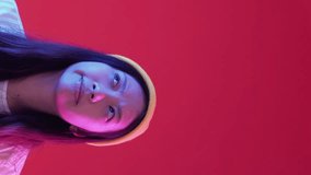 Vertical video. Idea thinking. Choosing solution. Vivid millennial puzzled woman considering problem question answers blue pink neon lights red background empty space. - Powered by Shutterstock - Get 15% off with code: PIKWIZARD15