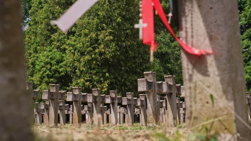 Tomb Cross at Polish Home Army Partisan Soldiers Military Cemetery World War 2 Memorial with Hanging Polish National Flag Band Sash and Prayer Rosary