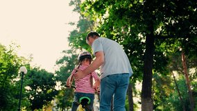 Child cyclist with Father, nature. Family weekend, Father teaches kid daughter to ride bike in park. Happy family, little girl in helmet together with her dad learns to ride bicycle outdoors in summer - Powered by Shutterstock - Get 15% off with code: PIKWIZARD15