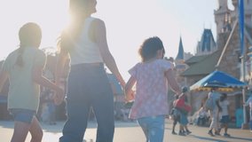 Asian mother and adorable kid daughters walking at the theme park. Happy family, attractive woman and little girls feel happy and relax while travel for vacation trip at beauty castle amusement park. - Powered by Shutterstock - Get 15% off with code: PIKWIZARD15