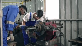 Diversity mechanic worker or metalworker using metal lathe machine operate polishing car disc brake at auto repair garage. Maintenance automotive and inspecting vehicle part concept - Powered by Shutterstock - Get 15% off with code: PIKWIZARD15