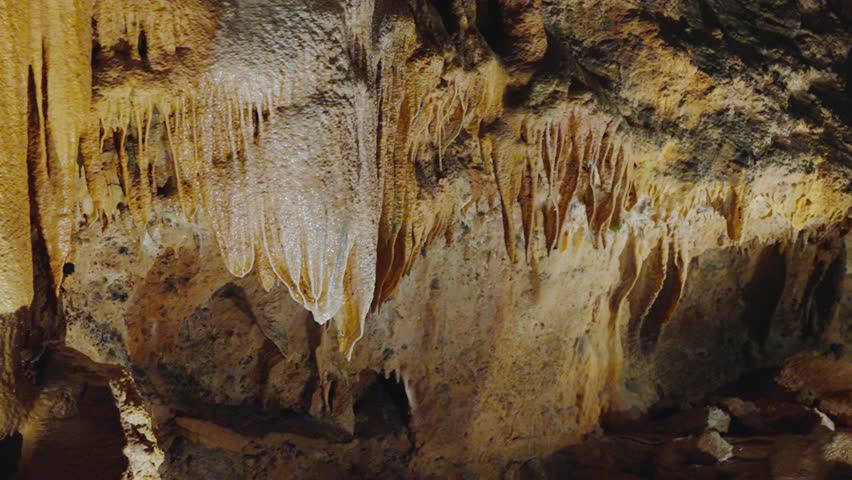 Stunning Stalactites and Stalagmites in a Portuguese Cave. Explore the natural beauty of a cave in Portugal, featuring hanging stalactites and rising stalagmites captured in vibrant details.