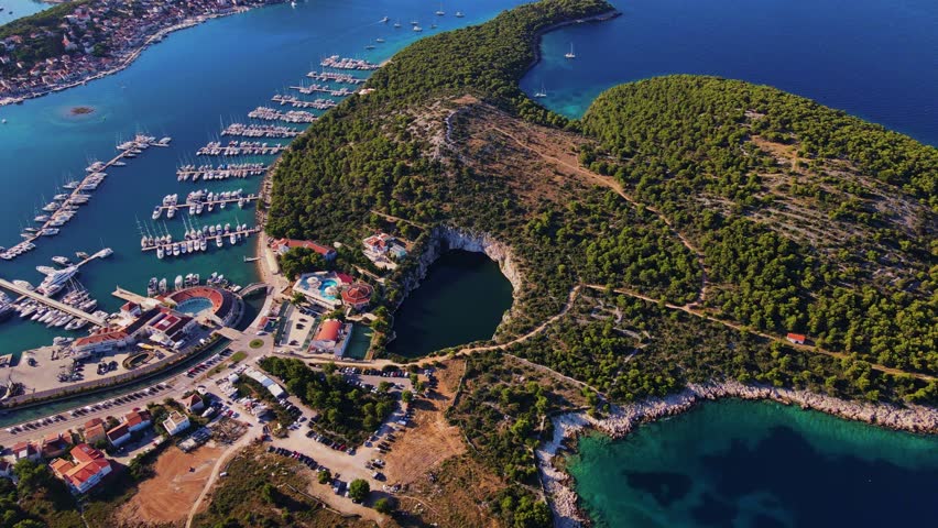 Aerial view of sea landscape with coastal town and yachts. Touristic city for summer vacation among Islands in Adriatic sea. Panoramic view of marina Frapa and Dragon Eye lake in Rogoznica, Croatia