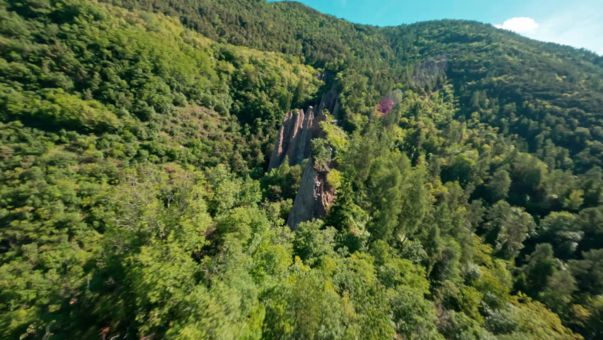 The stunning piramidi di terra di segonzano in a lush green forest, aerial view