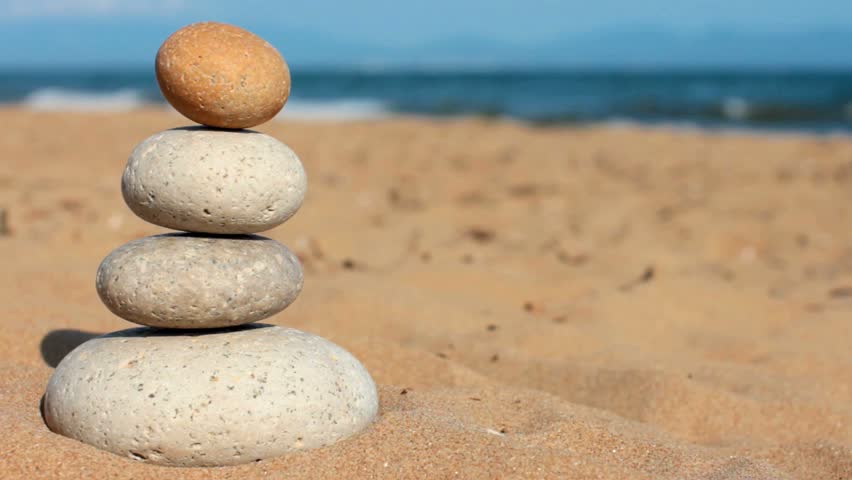 imbalance. Summer. Wild beach. someone's hand brakes equilibrium