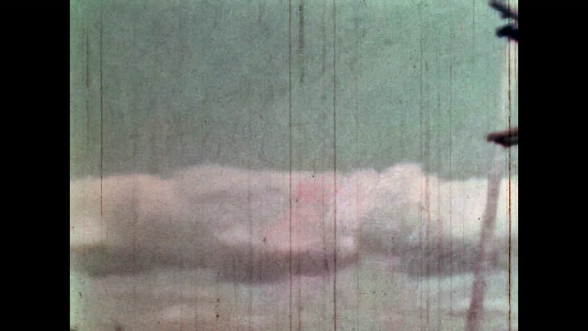 Electric power wires lead to transformer booth, distributes electricity. High voltage power lines on electric poles against sky backdrop, technical infrastructure. Vintage film. Retro 1960s archive