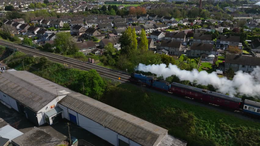 Steam Train, Drogheda, County Louth, Ireland, April 2023. Drone follows the Cú Chulainn Express pulled by No.85 Merlin Steam Locomotive as steams north to Dundalk.