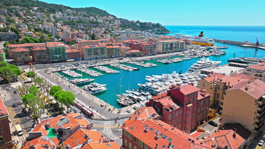 European elite houses with tiles on the roof and colourful buildings in Nice, France. Aerial view of French Riviera, a European resort in Nice.
