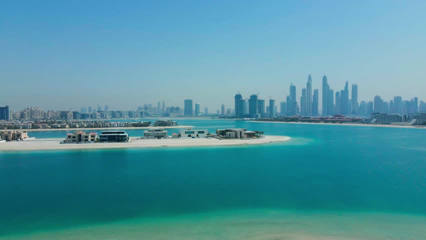 Aerial footage capturing the Dubai skyline from the fronds of Palm Jumeirah, showcasing the city