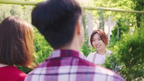 An Asian female consultant assists a loving couple, dressed in red, as they choose a tree for their home at a garden center. The couple stands with their backs to the camera. - Powered by Shutterstock - Get 15% off with code: PIKWIZARD15