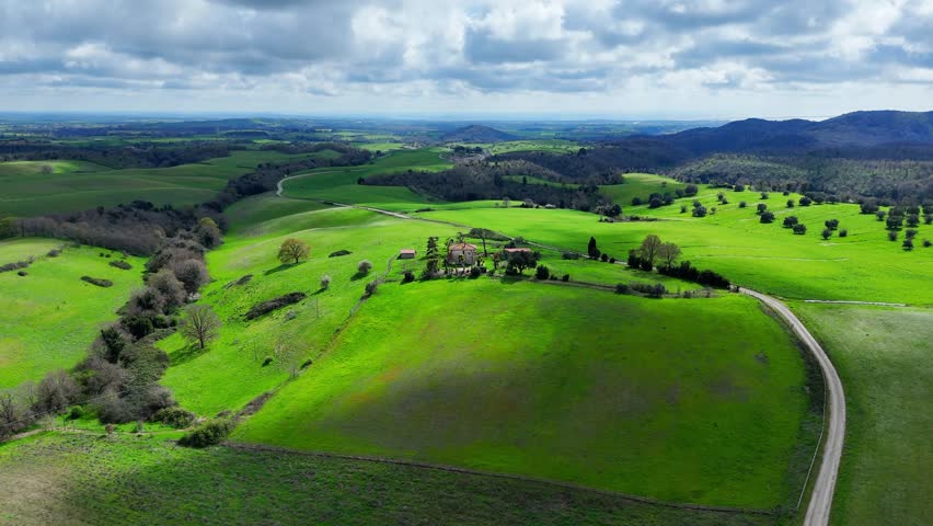 Breathtaking Aerial View Of Lush Green Fields Under Dramatic Clouds In Nature