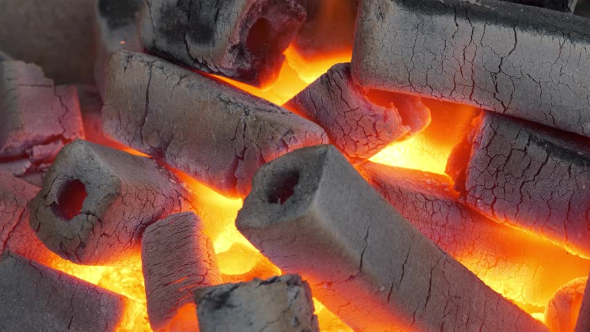 Burning fuel briquettes for barbecue, 4K Slow Motion one minute relax video