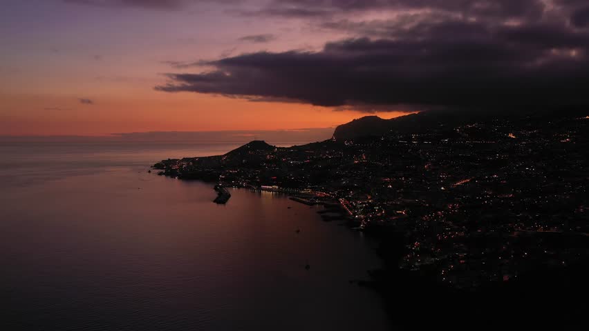Illuminated Funchal City at Night. Blue Hour. Madeira, Portugal. Aerial Drone Shot. Moving Forward and Upwards