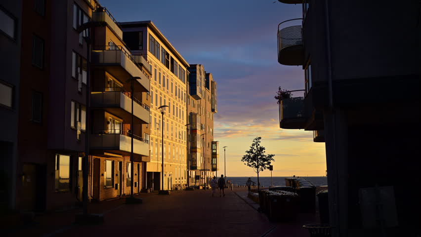 View of buildings on the shore of the sea in Malmo, Sweden at sunset