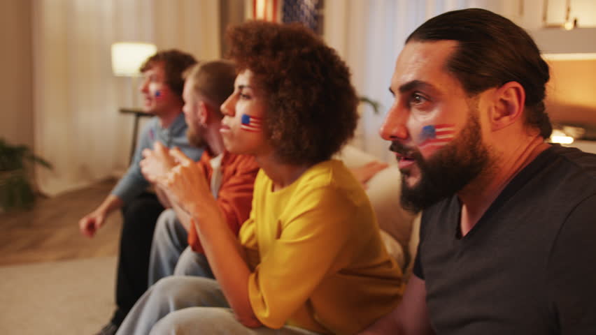 Nervous American football fans watching soccer match on tv, cheering for USA team. Sports and soccer fans. Slow Motion. 4K. European and World championship, USA, Canada, Mexico.