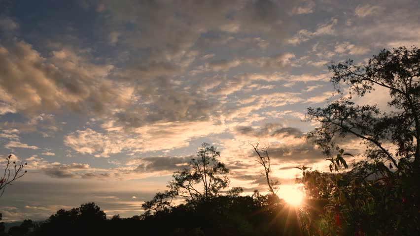 Time-lapse of slow moving clouds as the sun sets behind the eastern Andean mountains of central Colombia, near the Iguaque natural reserve. 
