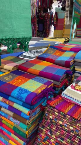 Vertical video of traditional mexican colorful clothes in Chiapas handcraft market