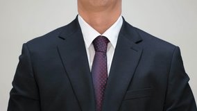 Man in white shirt and tie putting on jacket on a white background front view close-up. - Powered by Shutterstock - Get 15% off with code: PIKWIZARD15