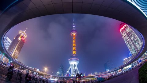 SHANGHAI - CIRCA 2013: Time Lapse of Night view of the East Pearl Tower under the Pedestrian Ring in Pudong, Shanghai, China. It was a Cloudy night with crowds traffic and automobile traffic