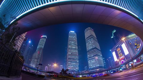 SHANGHAI - CIRCA 2013: Time Lapse of Night view of the IFC buildings under the Pedestrian Ring in Pudong, Shanghai, China. It was a Cloudy night with crowds traffic and automobile traffic