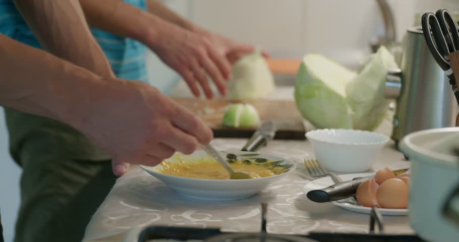 Close-up Preparing Omelet. Men Cook Food at Kitchen Preparing Breakfast. Slow motion 60fps 4K