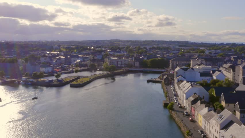 Aerial dynamic shot of the Long walk, River Corrib and vibrant Galway city