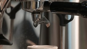 Espresso making process, coffee pouring from portafilter of coffee machine into espresso cup - Powered by Shutterstock - Get 15% off with code: PIKWIZARD15
