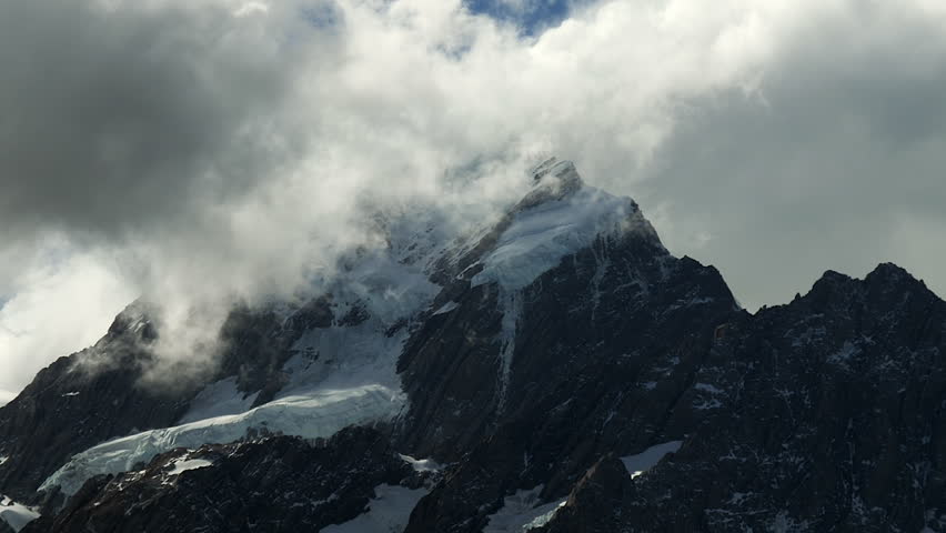 Mount Cook Aoraki summit peak in New Zealand shrouded in clouds - pullback reveal